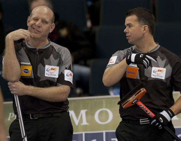 Edmonton's Kevin Martin, left, talks strategy with vice-skip David Nedohin during Monday afternoon's win over Jeff Stoughton. (Photo, CCA/Michael Burns)
