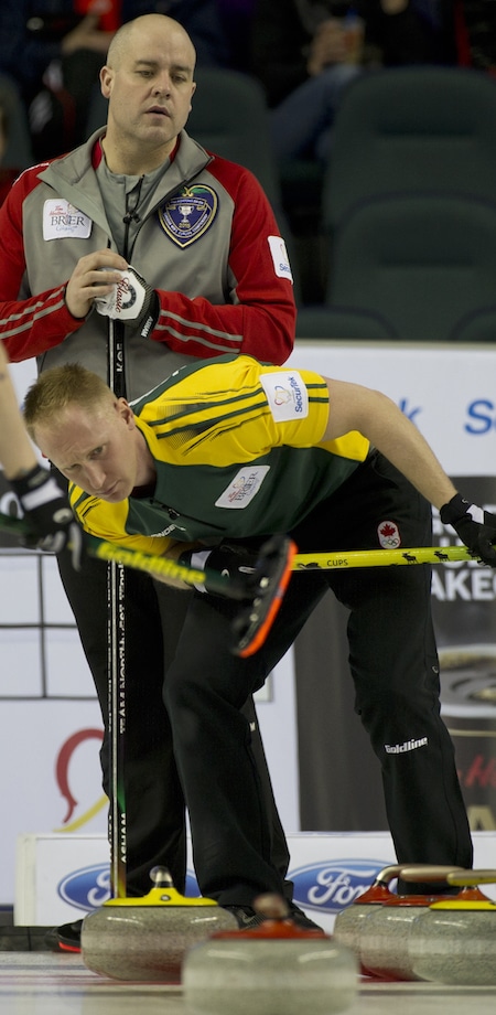 Northern Ontario skip Brad Jacobs looks for an angle, as Northwest Territories skip Jamie Koe looks on. (Photo, Curling Canada/Michael Burns)