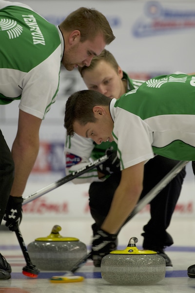 Saskatchewan skip Jacob Hersikorn watches as sweepers Cole Tenetiuk, left, and Brady Kendel keep things clean. (Photo, CCA/Michael Burns)