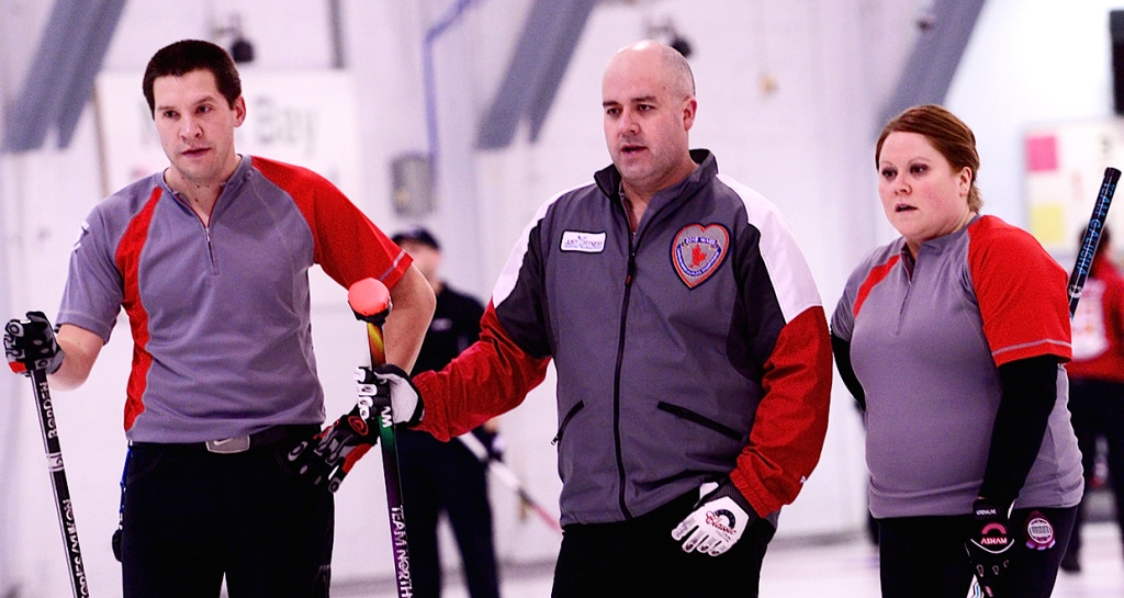 NT’s Robert Borden, Jamie Koe and Kerry Galusha consider the options during their Draw 11 game against Ontario at the 2015 Canadian Mixed Curling Championship in North Bay, Ont. (Brian Doherty Photography)