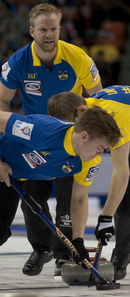 Sweden's Niklas Edin urges on sweepers Christoffer Sundgren, left, and Kristian Lindström. (Photo, Curling Canada/Michael Burns)