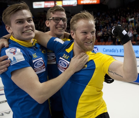 Niklas Edin, right, celebrates his Ford Worlds win with teammates Christoffer Sundgren, left, and Kristian Lindström. (Photo, Curling Canada/Michael Burns)