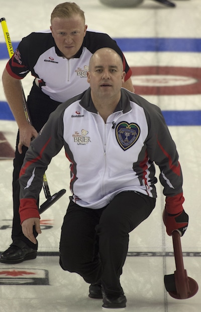 Jamie Koe of the Territories watches his shot as Ontario lead Scott Howard looks on. (Photo, Curling Canada/Michael Burns)