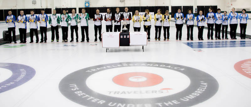 The medallists at the 2016 Travelers Curling Club Championship take to the ice in preparation for the trophy presentation at the Kelowna Curling Club (Curling Canada/Jessica Krebs photo)