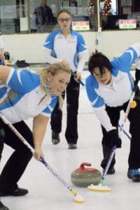 Team Quebec second Laurie Verreault and lead Sylvie Cote sweep skip Nathalie Gagnon's rock during action at the 2016 Travelers Curling Club Championship in Kelowna, B.C. (Curling Canada/Jessica Krebs photo)