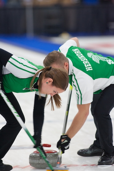 Saskatchewan sweepers Jacob Hersikorn and Krista Fesser hard at work (Curling Canada/Robert Wilson photo)