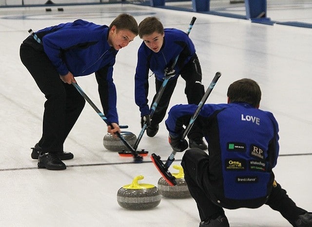 Vernon's Thomas Love (right) calls off sweepers Johnathan Schwartz (left) and Erik Colwell during Sunday afternoon's B final at the Prestige Hotels Rick Cotter Memorial Junior Curling Classic at the Vernon Curling Club (Photo by Roger Knox/Morning Star)