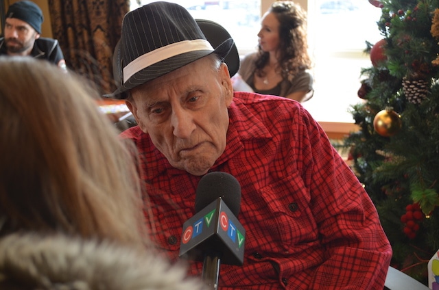 Saskatchewan’s 1955 Brier champ, Lloyd Campbell, is interviewed by local media at his 100th birthday celebration on Jan. 4 (Photo courtesy the Campbell family)