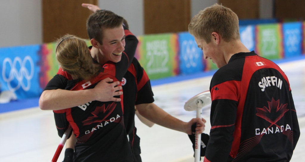 Derek Oryniak, Corryn Brown and Thomas Scoffin in the moments after winning their bronze medal on the ice in Innsbruck (Photo WCF/Richard Gray)