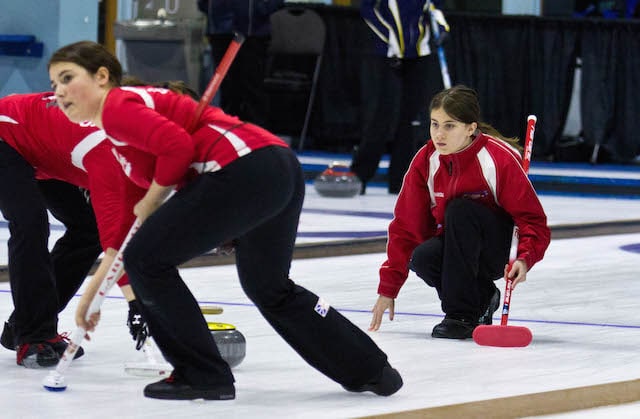 Spare Diamond Wilson, wearing Team NL third Chantal Newell’s jacket, delivers her rock during round-robin play at the 2015 Canada Winter Games in Prince George (Photo Vanessa Wilson)