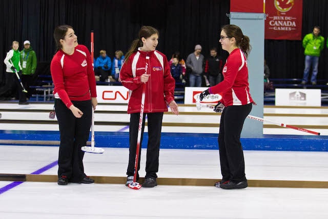 Prince George curler Diamond Wilson laughs with temporary teammates Lauren Barron and Sydney Parsons of Team Newfoundland and Labrador during action at the 2015 Canada Winter Games (Photo Vanessa Wilson)