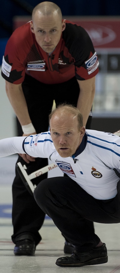 Ewan MacDonald de l'Ecosse montres son tir que Nolan Thiessen du Canada regarde par dessus son épaule. (Photo, Curling Canada / Michael Burns)