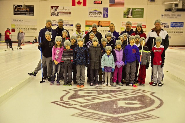 Young curlers and their instructors on the ice at Elmwood Curling Club in Winnipeg (Photo courtesy of B. Quesnel)