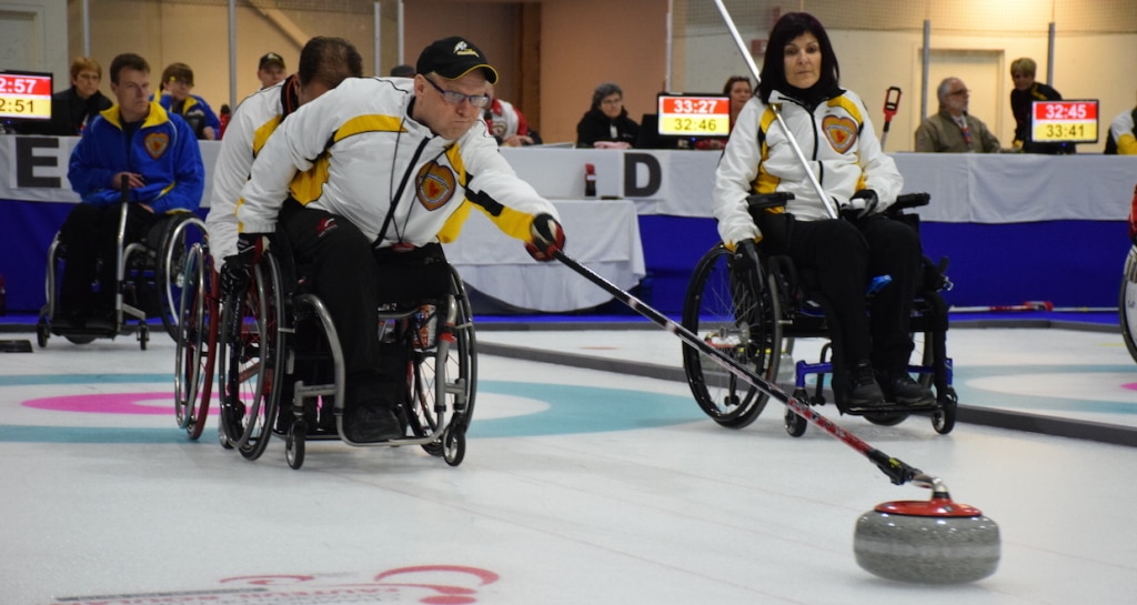 Manitoba's Dennis Thiessen delivers his rock during Draw 1 action at the 2015 Canadian Wheelchair Curling Championship (Photo Morgan Daw)