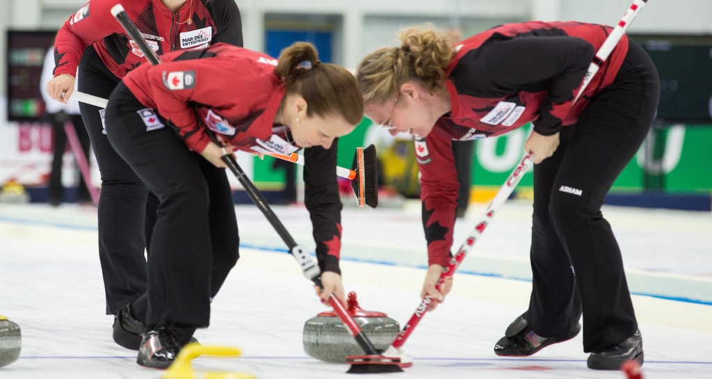 Allyson Stewart and Maureen Bonar sweep hard during action at the 2015 World Senior Curling Championships in Sochi, Russia (WCF/Céline Stucki Photo)