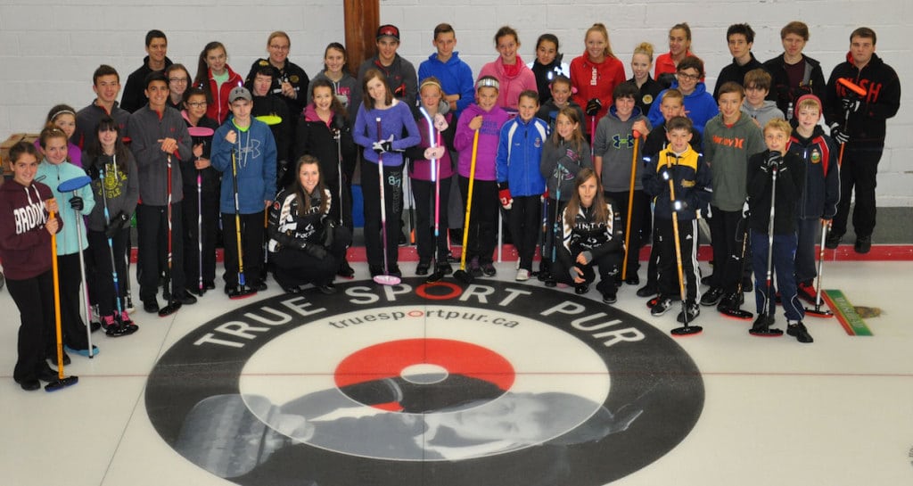 Members of the Ottawa Youth Curling League pose with Emma Miskew and Rachel Homan after a skills clinic (Photo Joe Pavia)