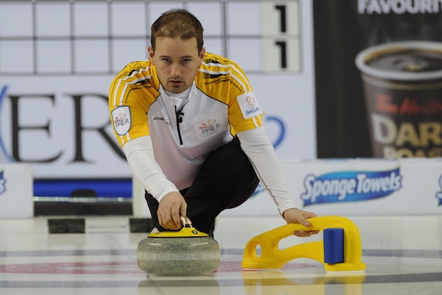 Reid Carruthers delivers a rock at the 2015 Tim Hortons Brier with assistance from his ProSlide (Curling Canada/Michael Burns photo)