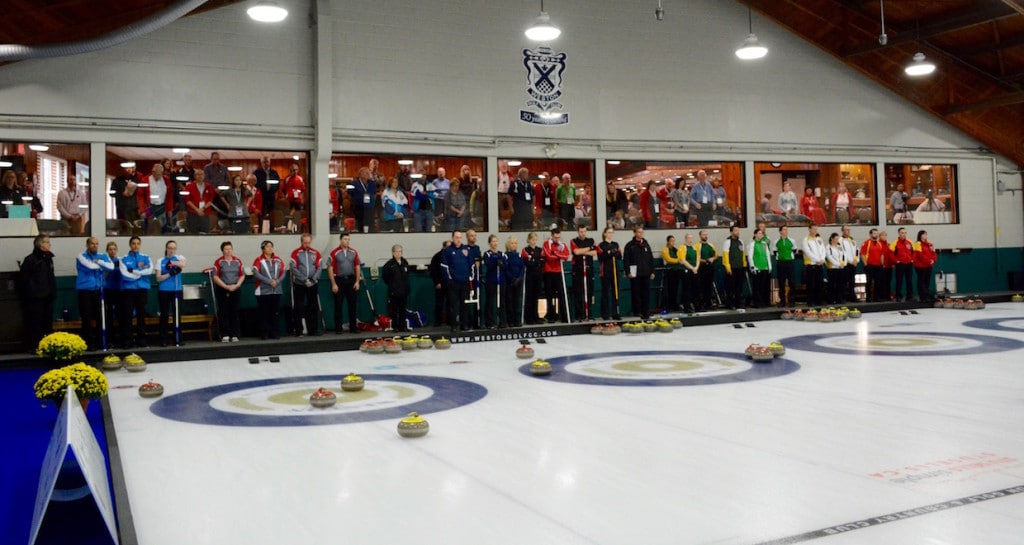 Teams at the Canadian Mixed Curling Championship stand for a moment of silence at 11 o'clock to mark Remembrance Day (Curling Canada/Sonja DiMarco Photo)