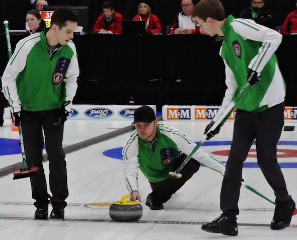 Jake Hersikorn delivers rock to sweepers Brady Kendel and Nick Neufeld during action Monday morning. (Photo, Curling Canada)