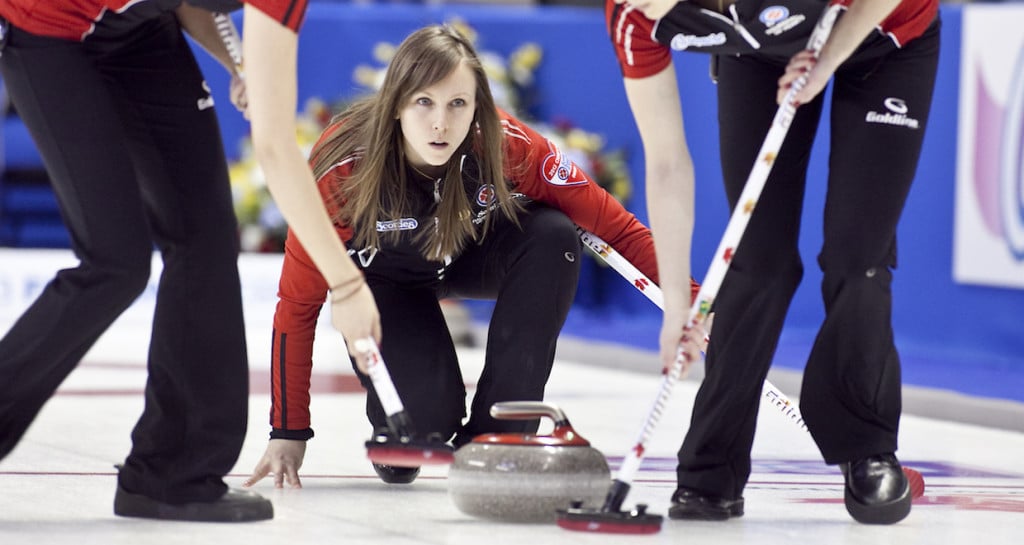 Ontario, Rachel Homan trows her rock as Alison Kreviazuk and Lisa Weagle, sweep in draw 14, at the 2013 Scotties Tournament of Hearts, February 16-24, Kingston Onatrio, The Canadian Womans Curling Championship.