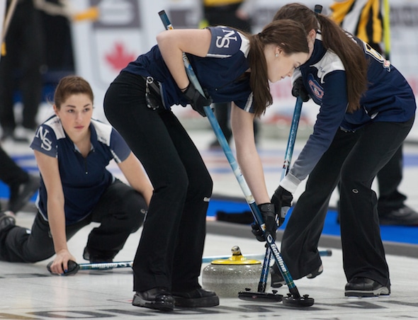 Nova Scotia second Karlee Burgess delivers rock to sweepers Janique LeBlanc, left, and Kristin Clarke. (Photo, Curling Canada/Bob Wilson)
