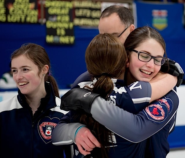 Nova Scotia skip Mary Fay, gets her hugs from teamates third Kristin Clarke, second Karlee Burgess after guiding her Chester Nova Scotia squad to a 9-5 victory over British Columbia in the woman's final at the 2016 Canadian Junior Curling Championship (Curling Canada/Michael Burns photo)