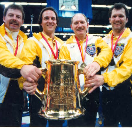 Vic Peters, left, and his teammates third Dan Carey, second Chris Neufeld and lead Don Rudd hoist the Labatt Tankard after winning the 1992 Brier. (Photo, Curling Canada/Michael Burns)