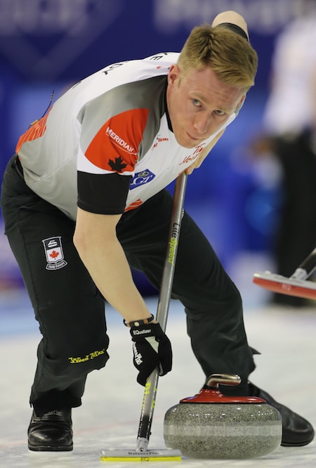 Team Canada vice-skip Marc Kennedy sweeps rock during Saturday's opening game. (Photo, World Curling Federation)