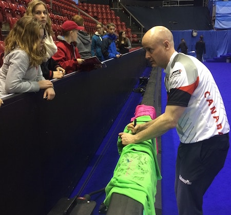 Team Canada skip Kevin Koe signs autographs for fans after Tuesday's win. (Photo, Curling Canada)