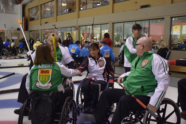 Teams Saskatchewan and Ontario shake hands after their game on the first day of competition at the 2016 Canadian Wheelchair Curling Championship at the Callie Curling Club in Regina (Curling Canada/Morgan Daw photo)