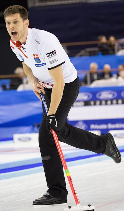 Danish skip Rasmus Stjerne urges on his sweepers. (Photo, World Curling Federation/Céline Stucki)