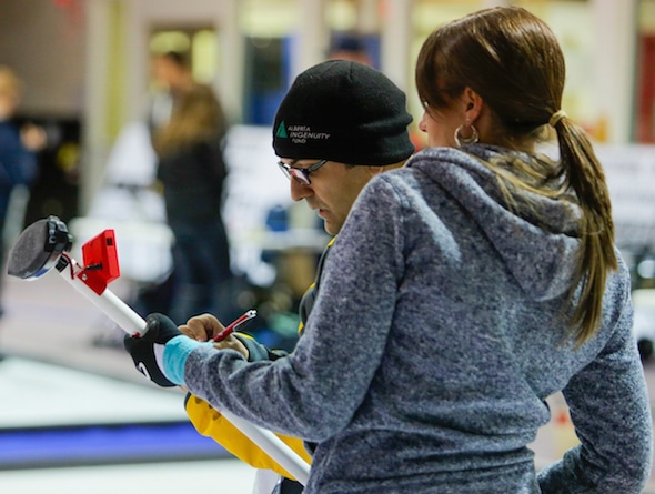 NRC's Louis Poirier (left) analyses data with curler Emma Miskew. (Photo, National Research Council/Dan Gamache)