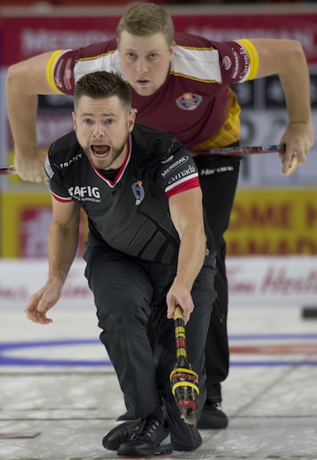 Brandon MB,November 30, 2016.Home Hardware Canada Cup of Curling.Skip Mike McEwen of Winnipeg Mb checks the stones line as  second Colton Flasch of Team Laycock of Saskatoon eyes the line during draw 2 of the Home Hardware Canada Cup of Curling. michael burns photo