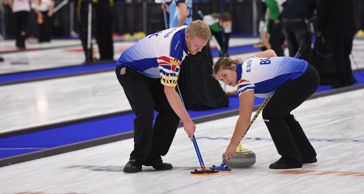 British Columbia second Miles Craig and lead Marike Van Osch sweep a rock down the ice at the Mariners Centre in Yarmouth, N.S., during round robin action at the 2017 Canadian Mixed Curling Championship (Curling Canada photo)