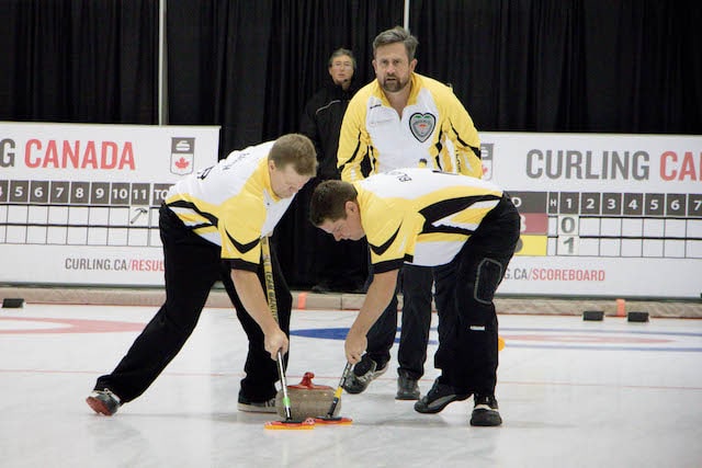 Manitoba skip Andrew Wickman watches the line and sweepers Mark Blanchard and Cam Barth during action at the 2016 Travelers Curling Club Championship in Kelowna, B.C. (Curling Canada/Jessica Krebs photo)