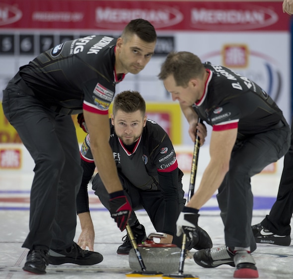 Mike McEwen, middle, and teammates Matt Wozniak, left, and Denni Neufeld picked up a key win on Thursday morning. (Photo, Curling Canada/Michael Burns)