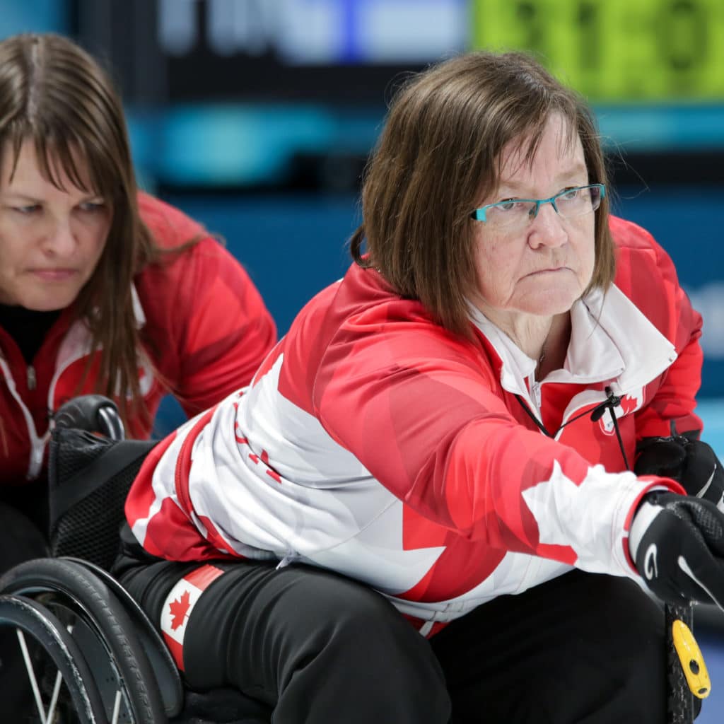 Ina Forrest hold the chair for Marie Wright as she delivers at the 29018 Paralympic Winter Games PyeongChang 2018.