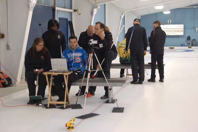 Instructor Codey Maus explains video results to curlers Sheila Smith, Margot Shepherd-Spurgeon, and Phil Coulter (Photo Jean MIlls)