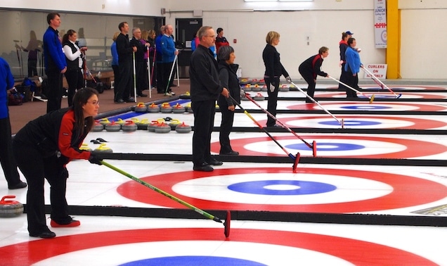 Skips hold the broom and teammates watch while a rock is delivered during The Great Shoot Out (Photo by Lisa Shamchuk)