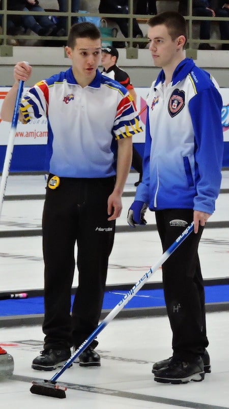 B.C. skip Tyler Tardi, right, discusses shot options with vice-skip Daniel Wenzek during Sunday night's win. (Photo, Curling Canada)