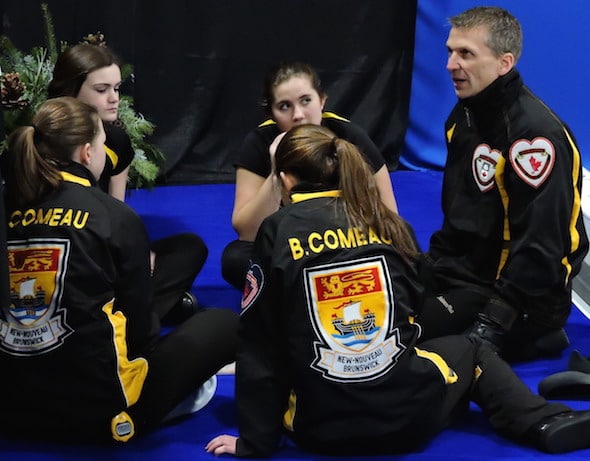 New Brunswick coach Tim Comeau, right, speaks to his team during during the fifth-end break on Monday. (Photo, Curling Canada)