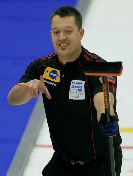 St.Albert Alta,Jan15_2011.WFG Continental Cup Curling.Team North America's Ben hebert of Edmonton,gives the signal after completing his shot in the singles competition.The lead on Team Martin assists in their 27-16 over Team Murdoch. michael burns photo