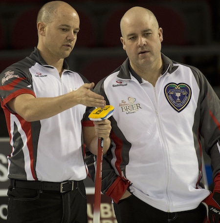 Team Northwest Territories vice-skip Chris Schille, left, and skip Jamie Koe discuss their shot options. (Photo, Curling Canada/Michael Burns)