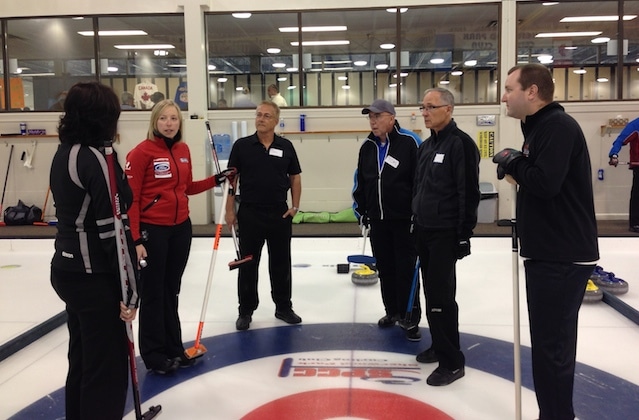 Beth Iskiw gives feedback to a group of adult curlers at the Pros in the Park Curling Camp (Photo courtesy H. Nedohin)