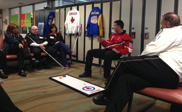 Former Brier and World champions David Nedohin (centre) and Randy Ferbey (right) provide strategy tips during a session at the Sherwood Park Curling Club (Photo courtesy H. Nedohin)