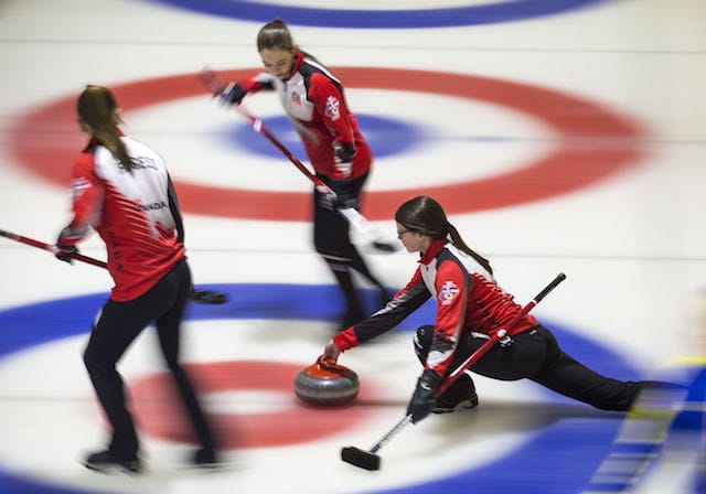 Team Canada's Janique LeBlanc and Karlee Burgess prepared to sweep as skip Mary Fay delivers at the Taarnby Curling Club during the 2016 World Junior Curling Championship (WCF/Marissa Tiel photo)