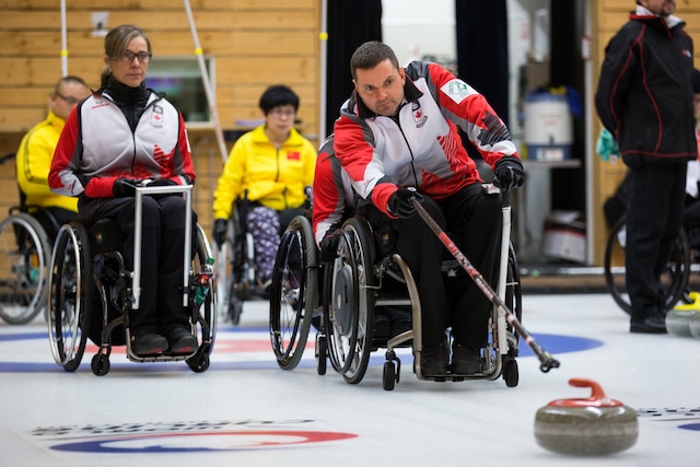 Team Canada second Sonja Gaudet watches as lead Mark Ideson delivers his rock at the 2016 World Wheelchair Curling Championship on Tuesday morning in Lucerne, Switzerland (WCF/Céline Stucki photo)